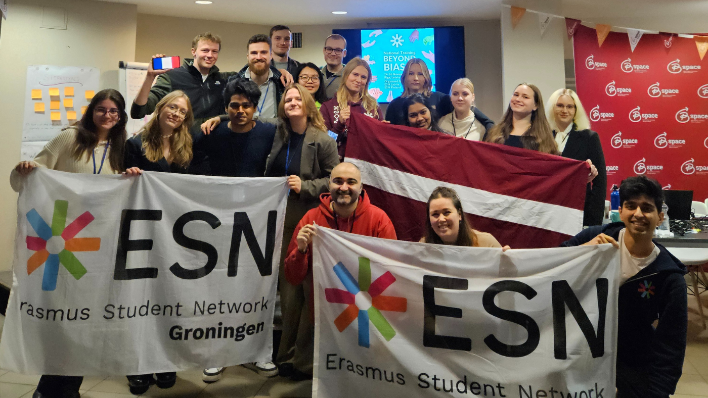 A group picture with around 20 people holding ESN flags.