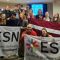 A group picture with around 20 people holding ESN flags.