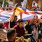 A big group of people in a parade with country flags.