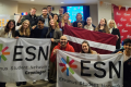 A group picture with around 20 people holding ESN flags.